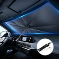 Umbrella-style sun shade open across a car windshield