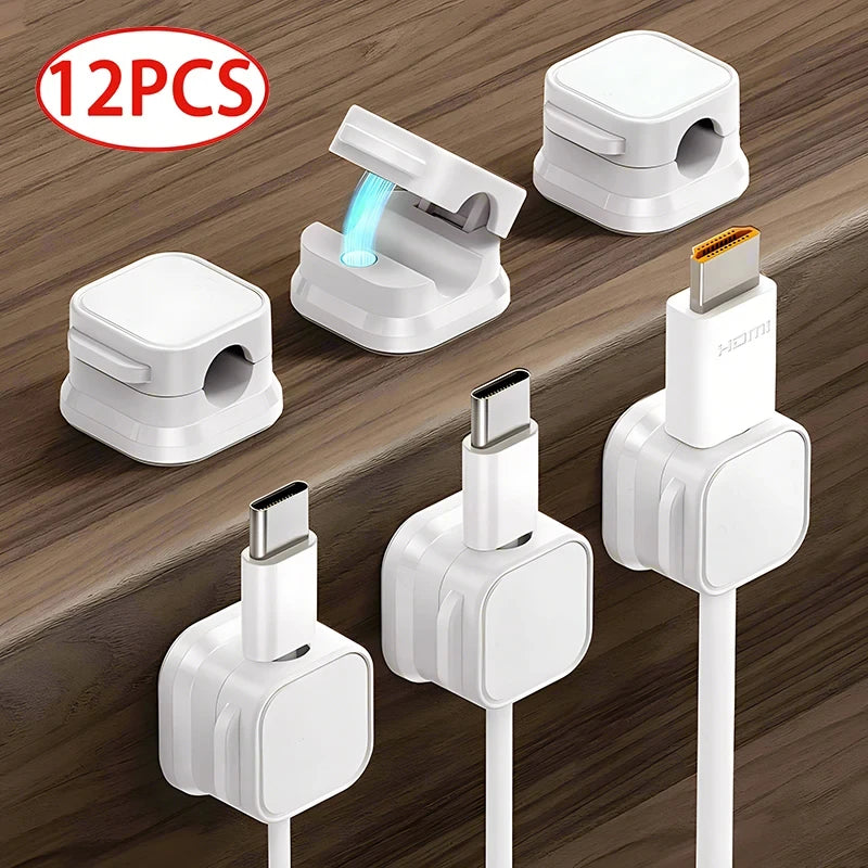 Magnetic cable clips holding charging cables on desk